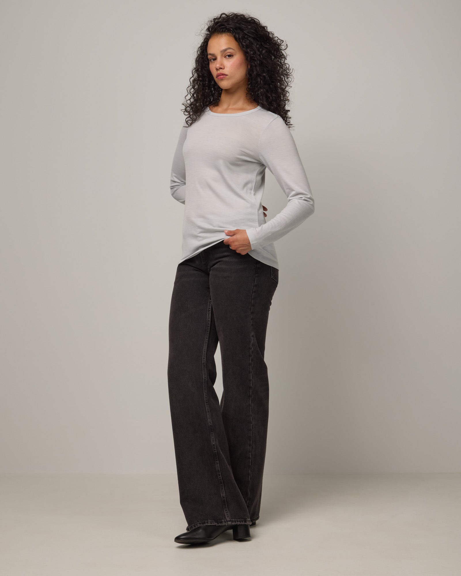 Model wearing Sloan Signature Fitted Tee in Light Gray End-on-End. Sloan Signature Fitted Tee is a merino wool long sleeve, crew neck, slim fit tee available in sizes XS-3X.