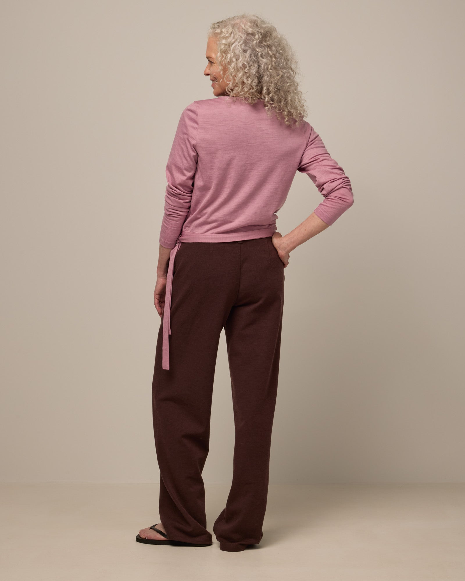 Model wearing Carson Ponte Trouser in Espresso, a warm brown color. Carson Ponte Trouser is a merino wool pant with pockets available in sizes XS-3X Regular, XS-XL Petite.