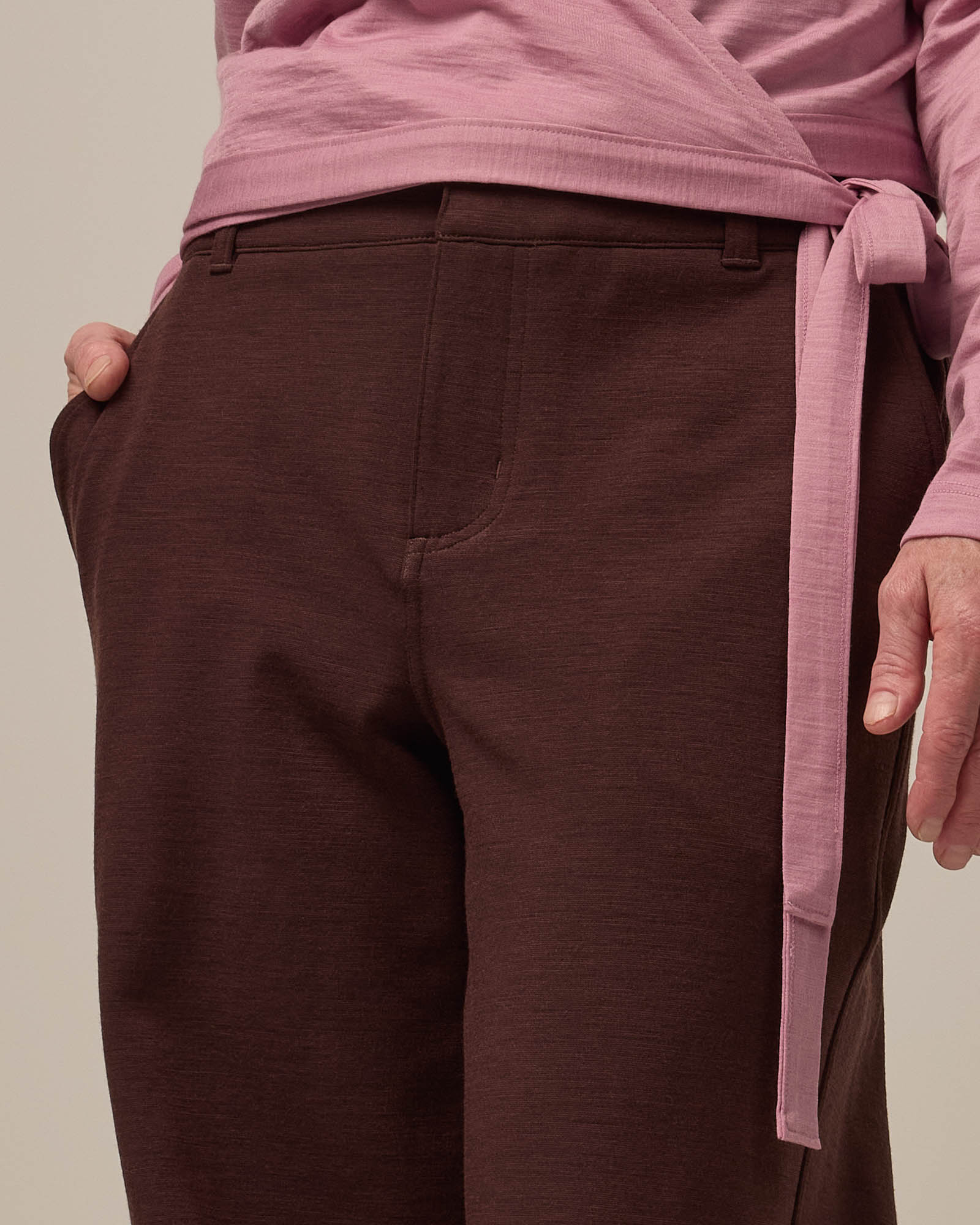 Model wearing Carson Ponte Trouser in Espresso, a warm brown color. Carson Ponte Trouser is a merino wool pant with pockets available in sizes XS-3X Regular, XS-XL Petite.