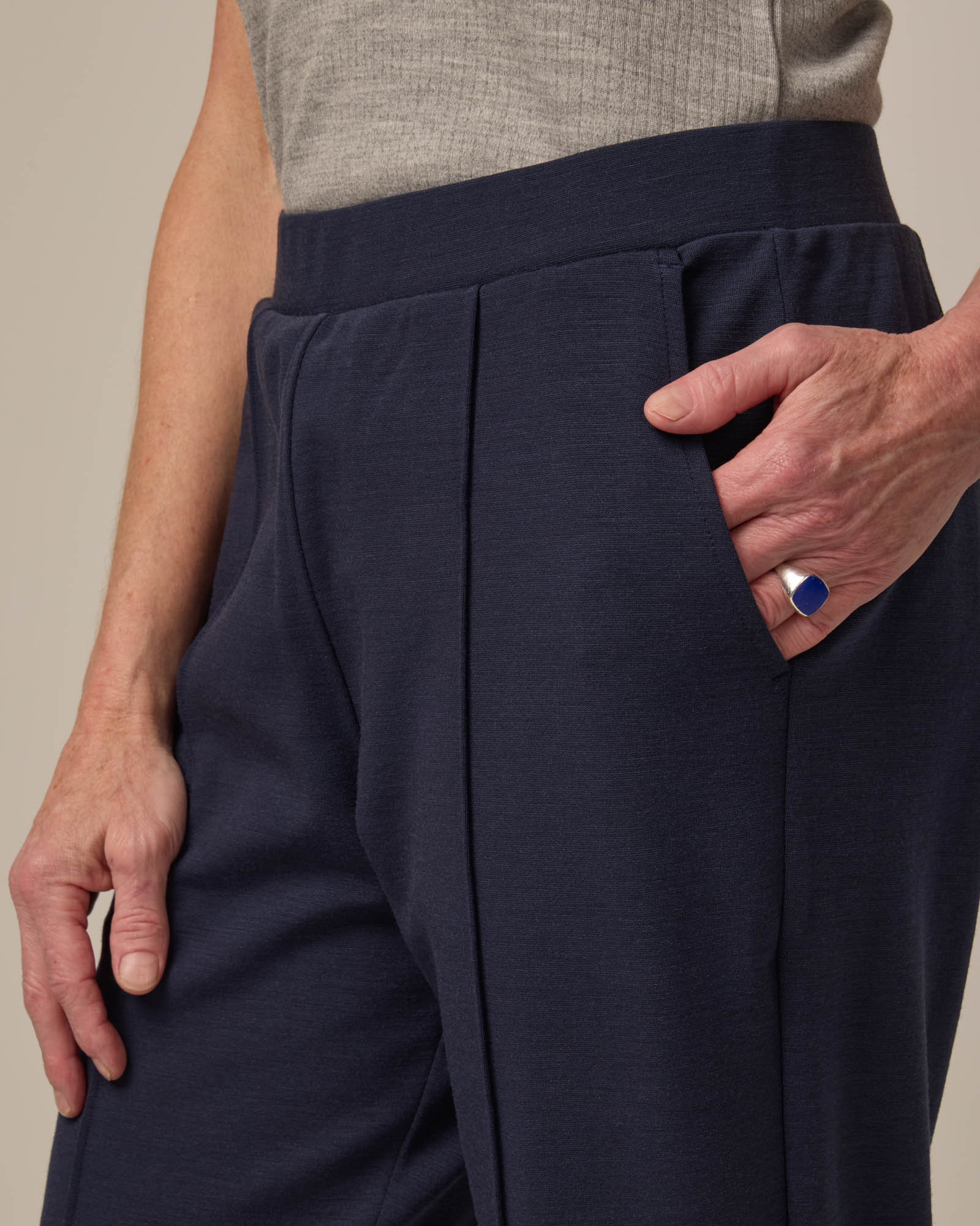 Model wearing Rosso Straight Ponte Pant in Washed Navy. Rosso Straight Ponte Pant is a merino wool pant with pockets available in sizes XS-3X Regular, S-XXL Long.