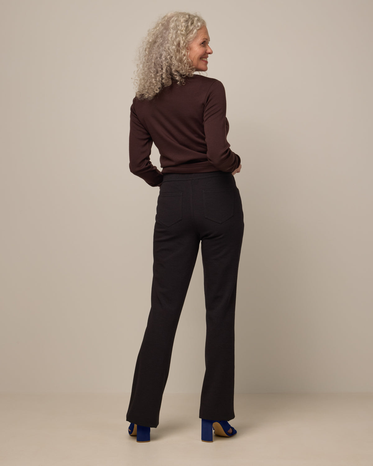 Model wearing Foster Kick Flare Ponte Pant in Black. Foster Kick Flare Ponte Pant is a merino wool flare pant available in sizes S-3X Regular, S-XL Long, and XS-XL Petite.