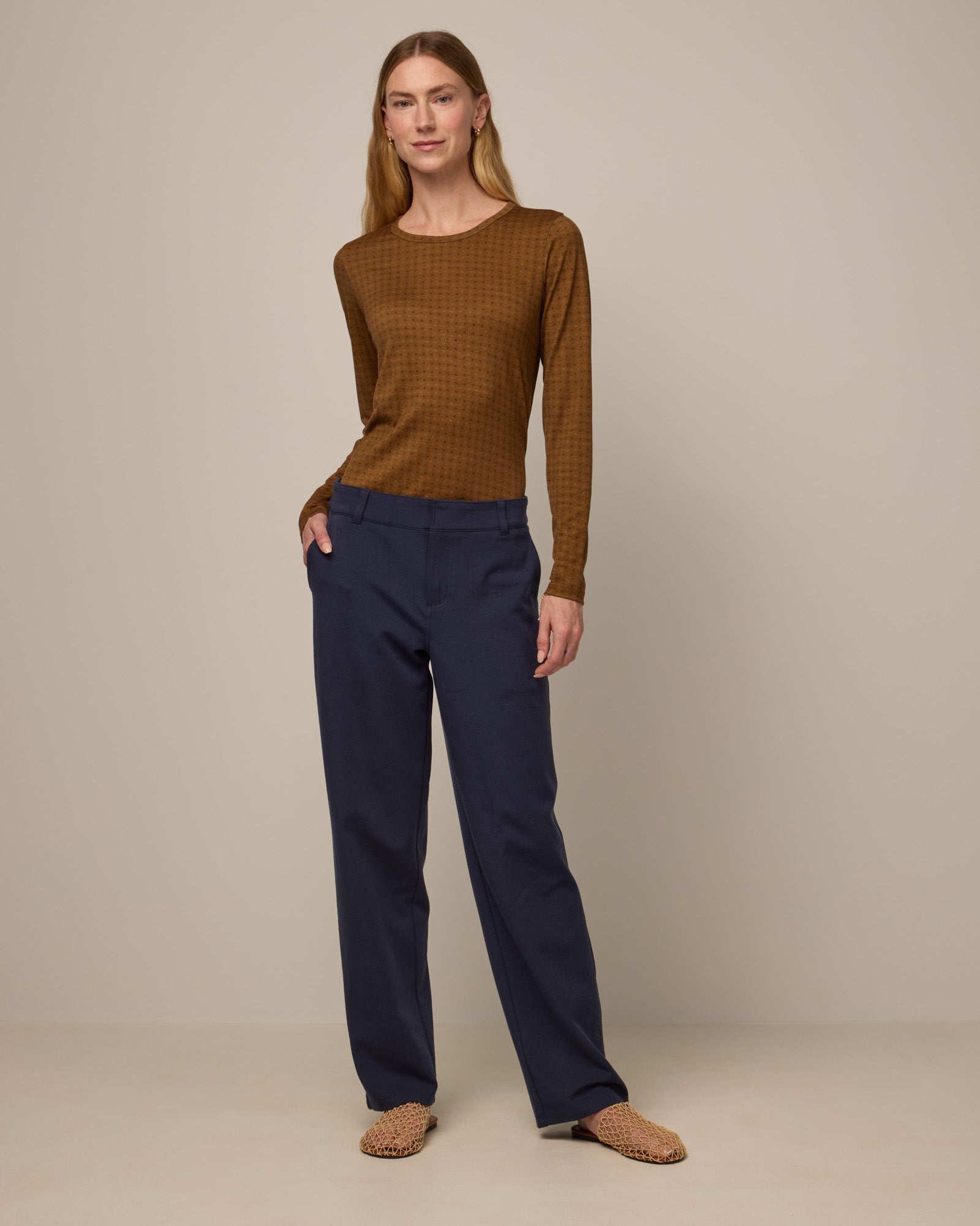 Model wearing Carson Ponte Trouser in Washed Navy. Carson Ponte Trouser is a merino wool pant with pockets available in sizes XS-3X Regular, XS-XL Petite.
