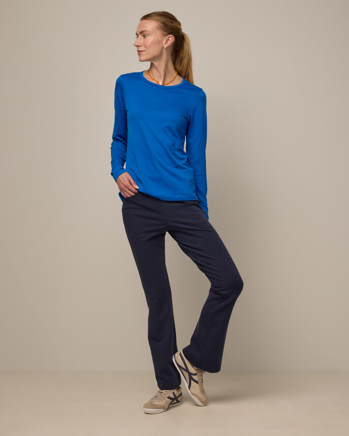 Model wearing Foster Kick Flare Ponte Pant in Washed Navy. Foster Kick Flare Ponte Pant is a merino wool flare pant available in sizes S-3X Regular, S-XL Long, and XS-XL Petite.