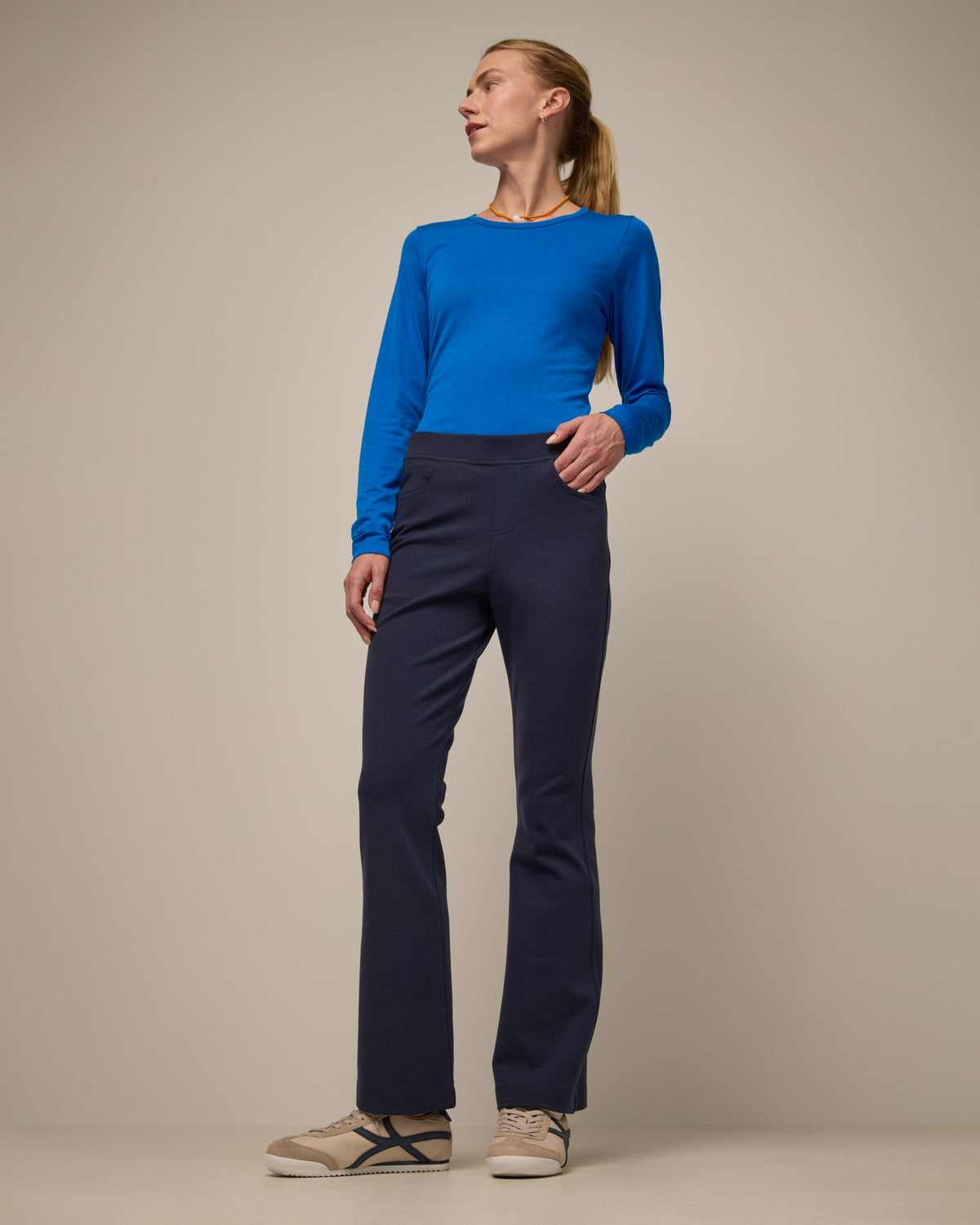 Model wearing Foster Kick Flare Ponte Pant in Washed Navy. Foster Kick Flare Ponte Pant is a merino wool flare pant available in sizes S-3X Regular, S-XL Long, and XS-XL Petite.