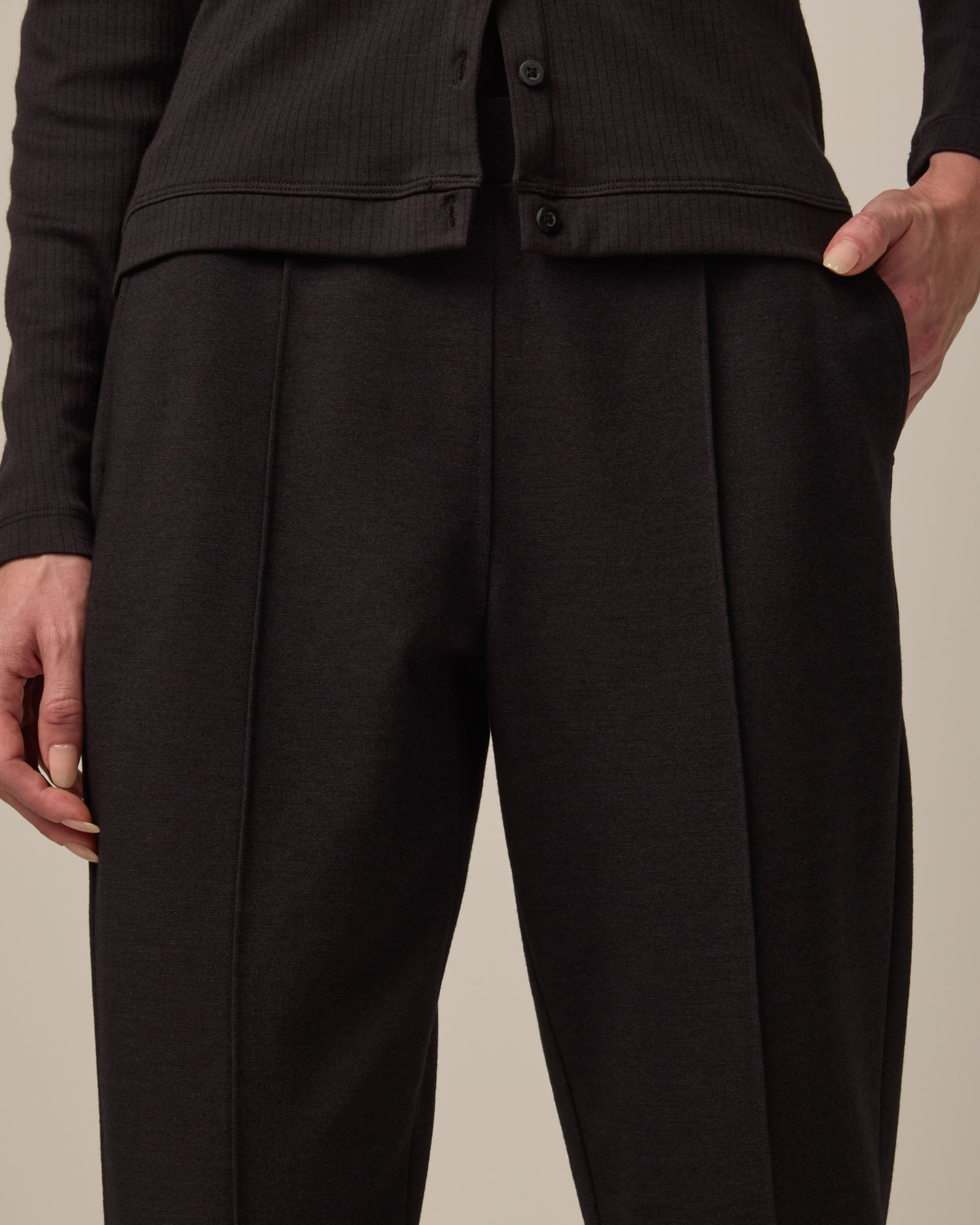 Model wearing Rosso Straight Ponte Pant in Black. Rosso Straight Ponte Pant is a merino wool pant with pockets available in sizes XS-3X Regular, S-XXL Long.
