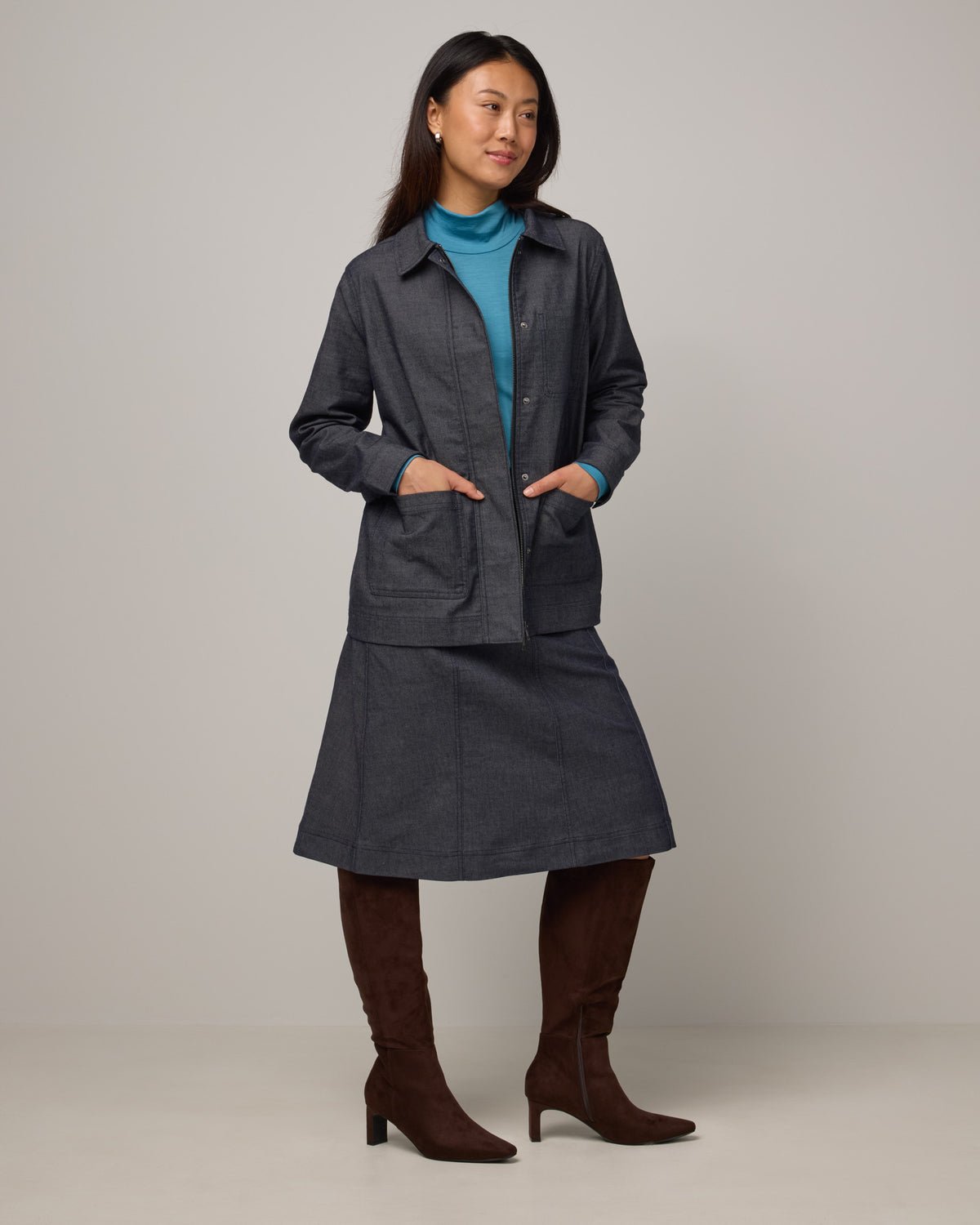Model wearing Andi Denim Chore Jacket in Indigo Blue. Andi Denim Chore Jacket is a merino wool long sleeve, collared, relaxed fit jacket available in sizes XS-XXL.