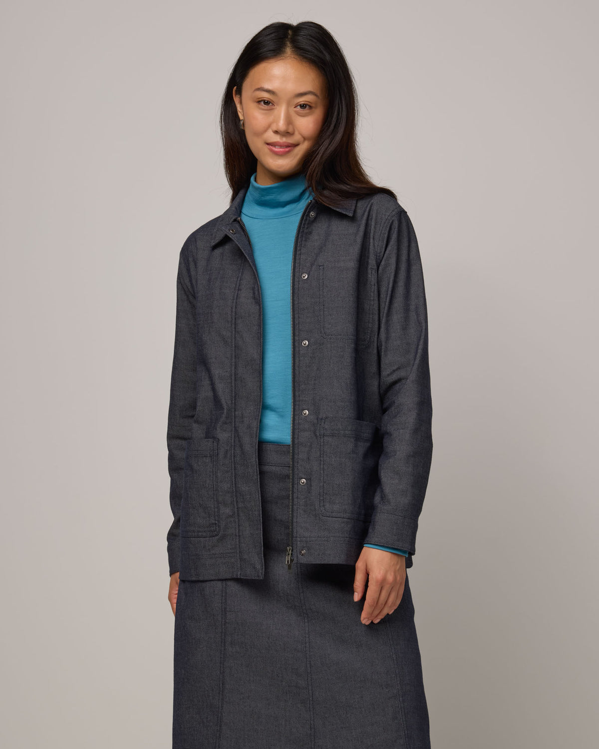 Model wearing Andi Denim Chore Jacket in Indigo Blue. Andi Denim Chore Jacket is a merino wool long sleeve, collared, relaxed fit jacket available in sizes XS-XXL.