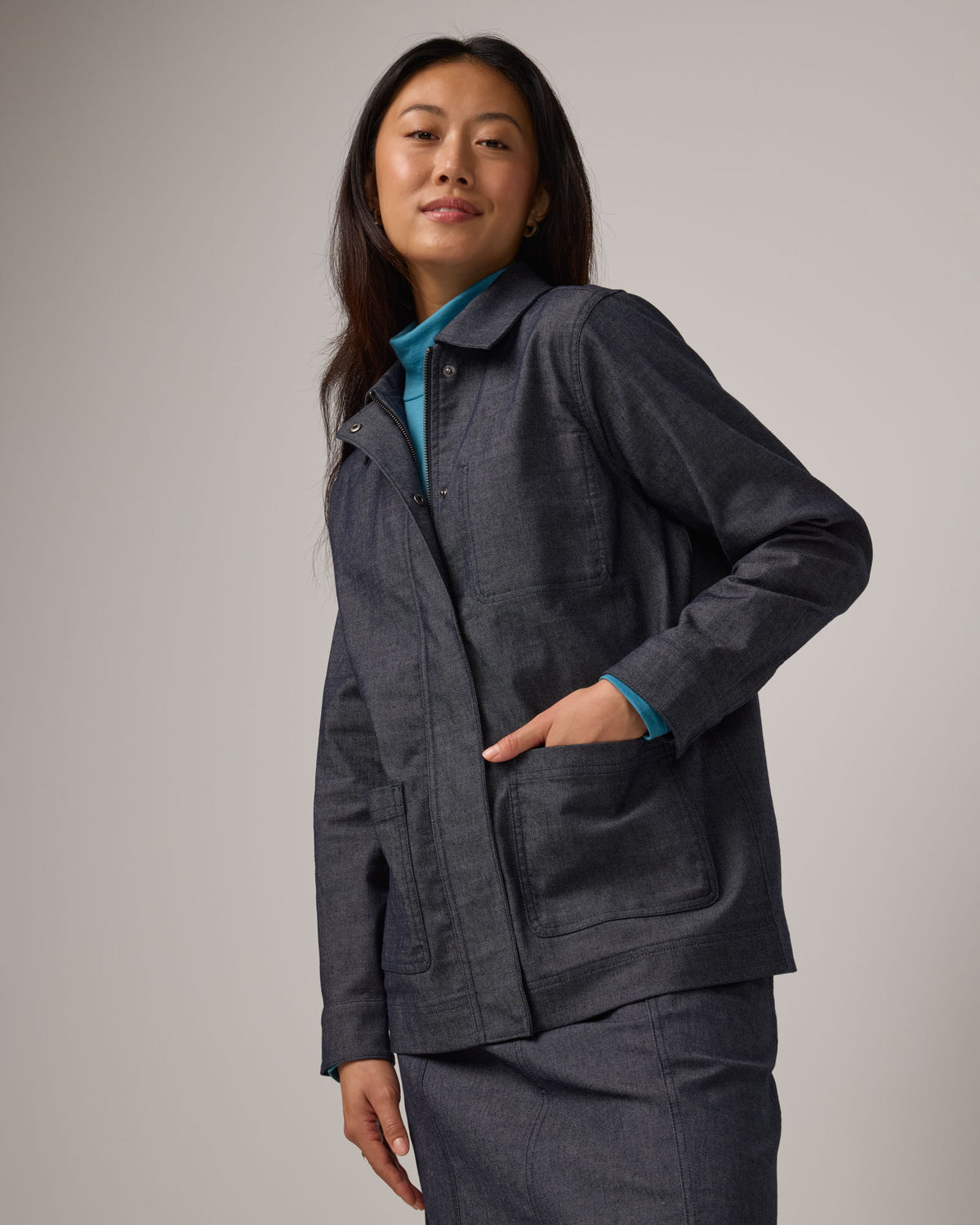 Model wearing Andi Denim Chore Jacket in Indigo Blue. Andi Denim Chore Jacket is a merino wool long sleeve, collared, relaxed fit jacket available in sizes XS-XXL.
