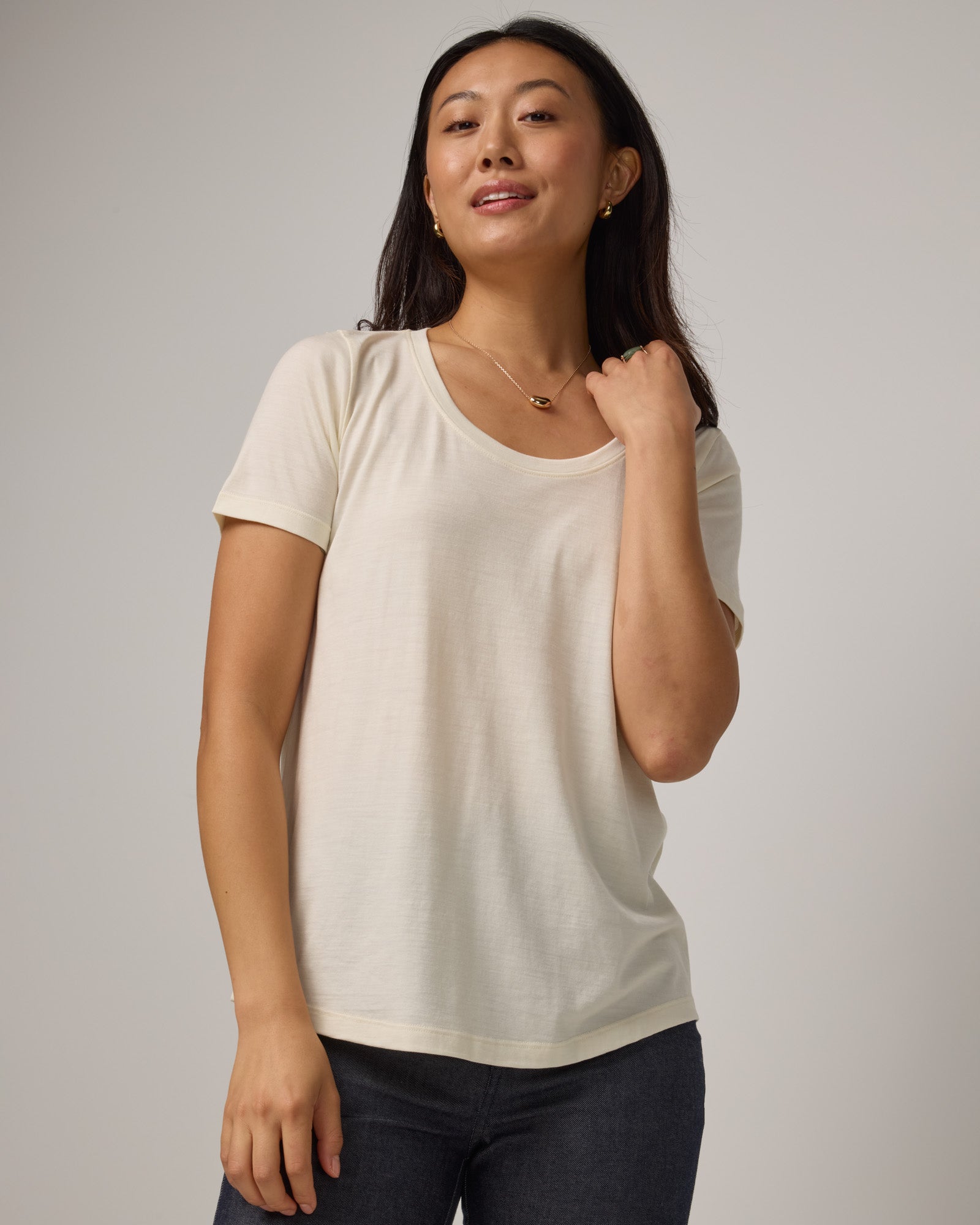 Model wearing Stella Scoop Neck Tee in Natural White. Stella Scoop Neck Tee is a merino wool short sleeve, scoop neck t-shirt available in sizes XS-3X.