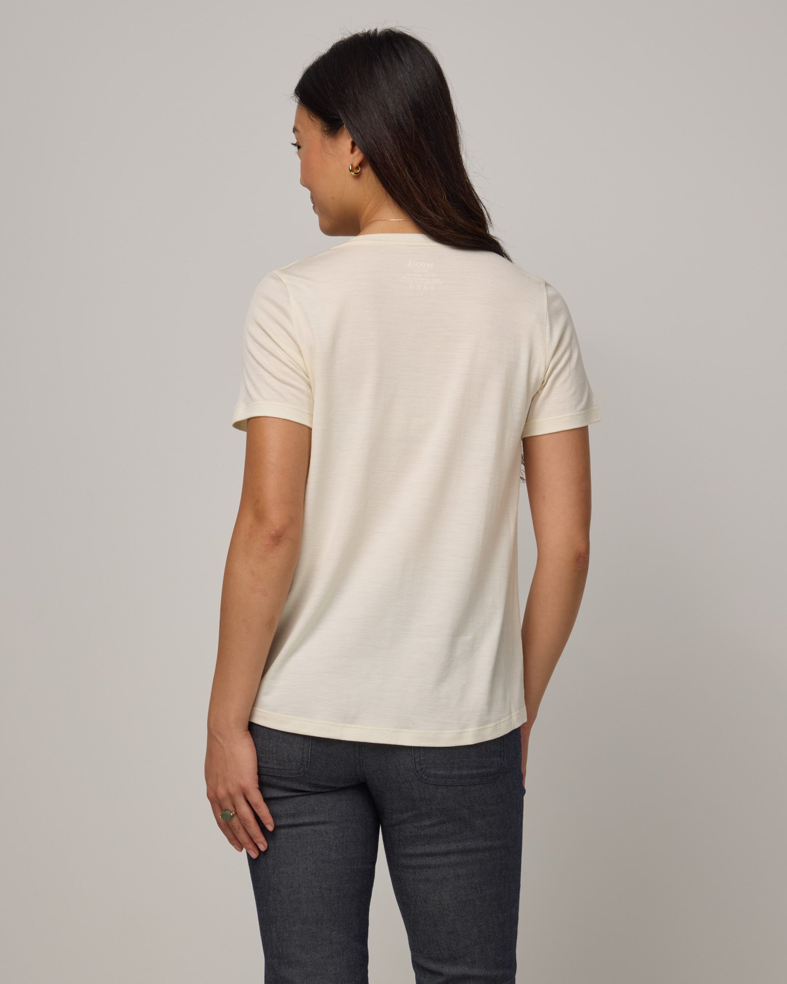 Model wearing Stella Scoop Neck Tee in Natural White. Stella Scoop Neck Tee is a merino wool short sleeve, scoop neck t-shirt available in sizes XS-3X.