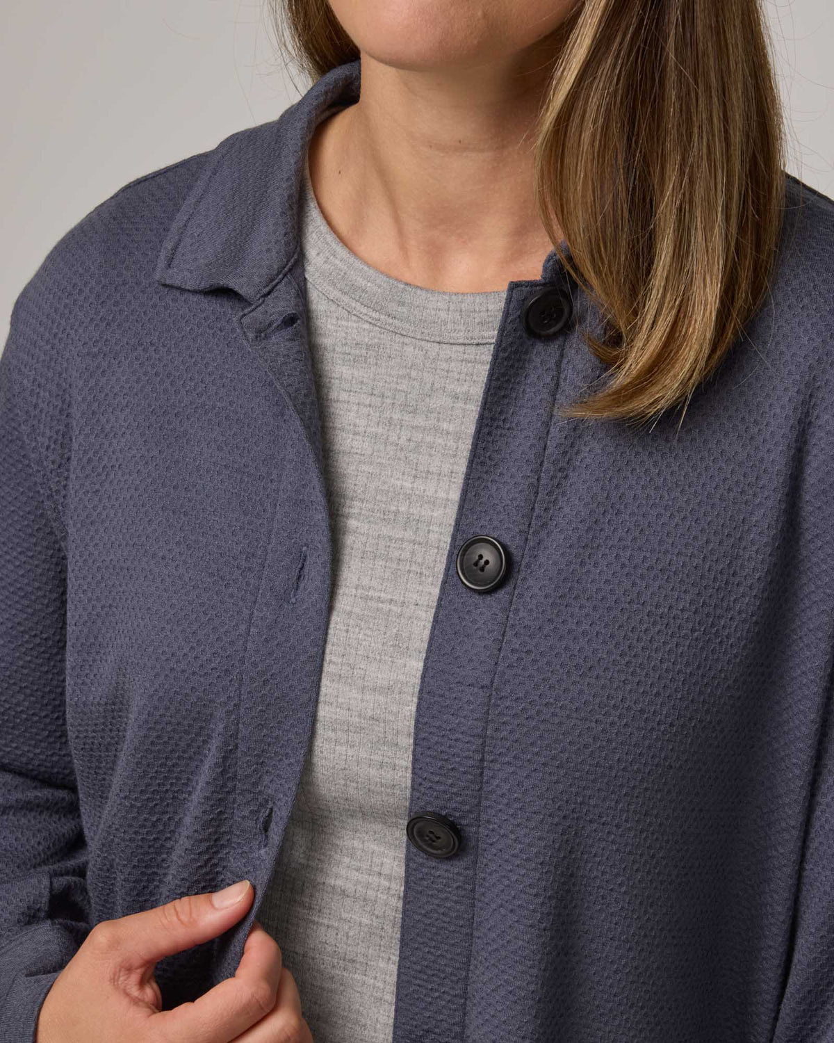 Model wearing Dani Relaxed Button-Front Shirt in Odyssey Gray, a slate blue-gray color. Dani Relaxed Button-Front Shirt is a merino wool long sleeve, collared button-down shirt available in sizes XS-3X.