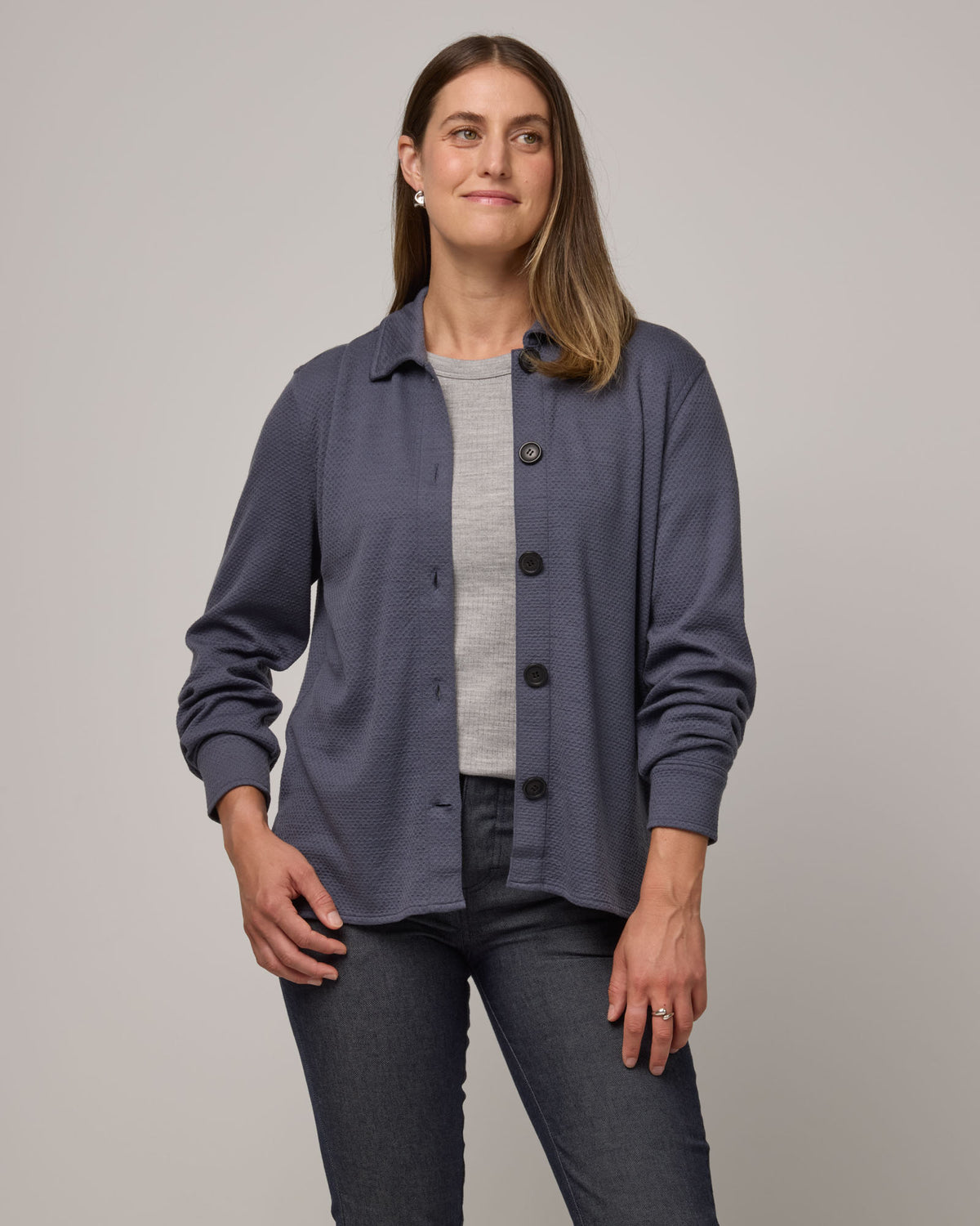 Model wearing Dani Relaxed Button-Front Shirt in Odyssey Gray, a slate blue-gray color. Dani Relaxed Button-Front Shirt is a merino wool long sleeve, collared button-down shirt available in sizes XS-3X.