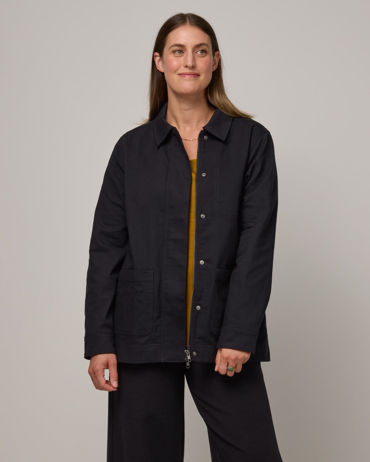 Model wearing Andi Denim Chore Jacket in Black. Andi Denim Chore Jacket is a merino wool long sleeve, collared, relaxed fit jacket available in sizes XS-XXL.