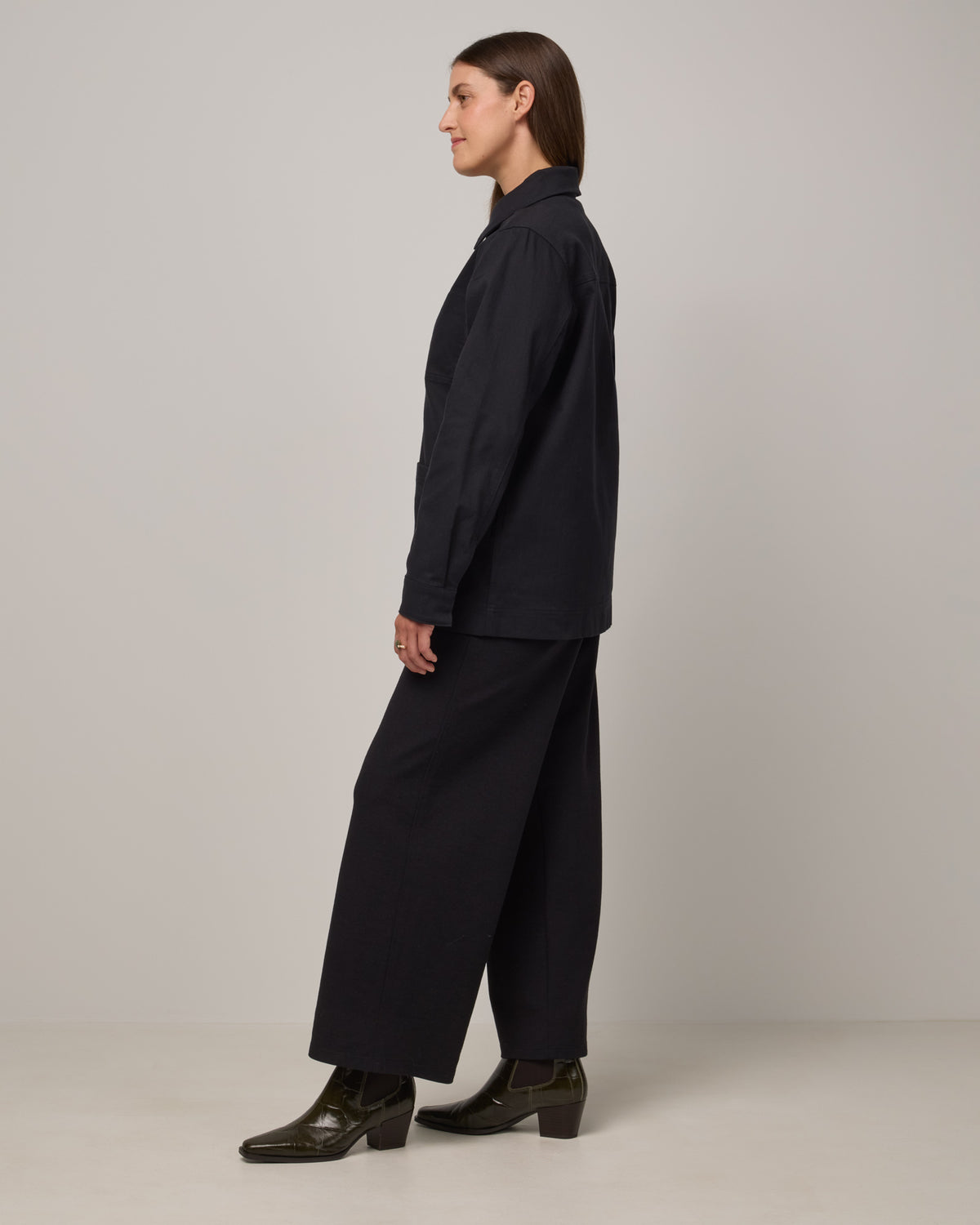 Model wearing Andi Denim Chore Jacket in Black. Andi Denim Chore Jacket is a merino wool long sleeve, collared, relaxed fit jacket available in sizes XS-XXL.