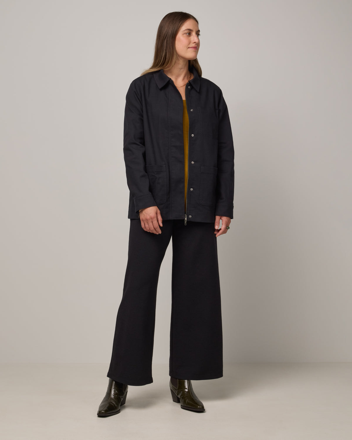 Model wearing Andi Denim Chore Jacket in Black. Andi Denim Chore Jacket is a merino wool long sleeve, collared, relaxed fit jacket available in sizes XS-XXL.