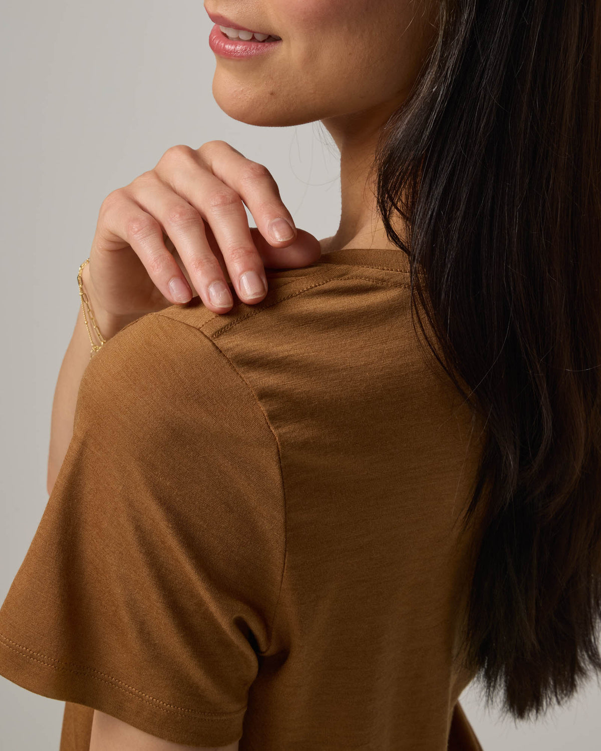 Model wearing Zoe Easy Crew Neck Tee in Camel, a caramel brown color. Zoe Easy Crew Neck Tee is a merino wool short sleeve, crew neck, regular fit tee available in sizes XS-3X.