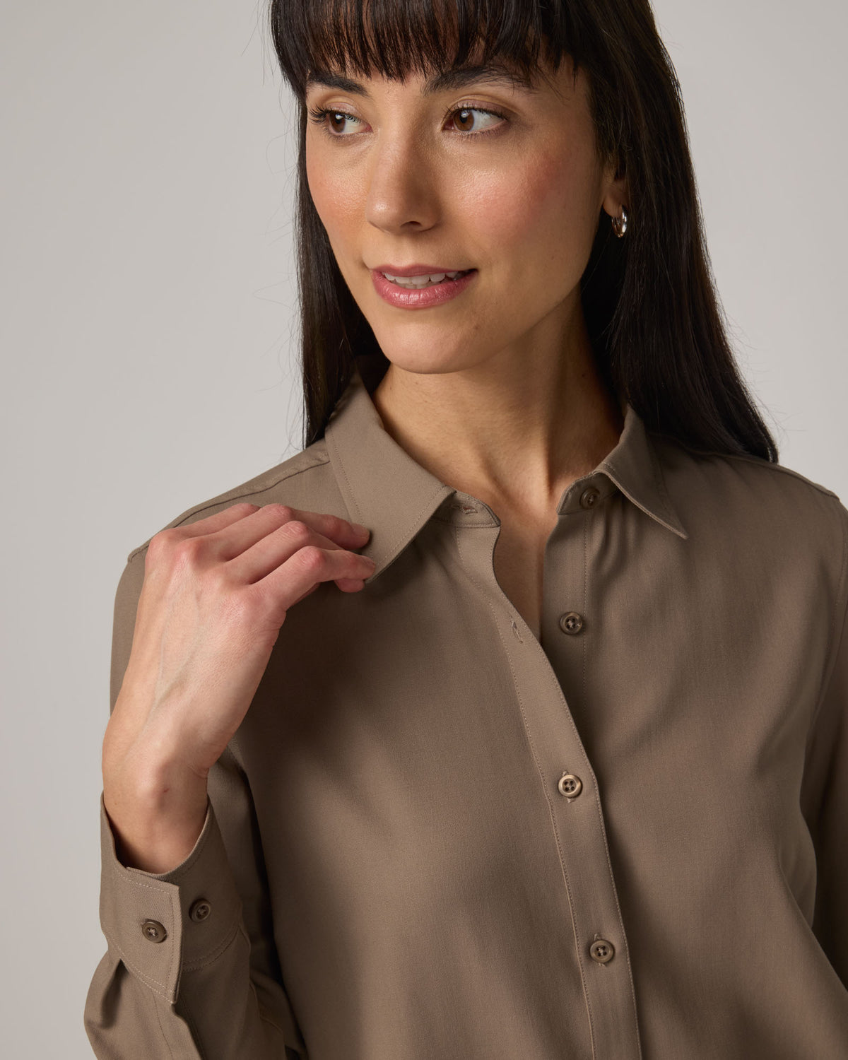 Model wearing Tiffany Button-Front Shirt in Walnut, a taupe brown color. Tiffany Button-Front Shirt is a merino wool long sleeve collared shirt available in sizes XS-XXL.