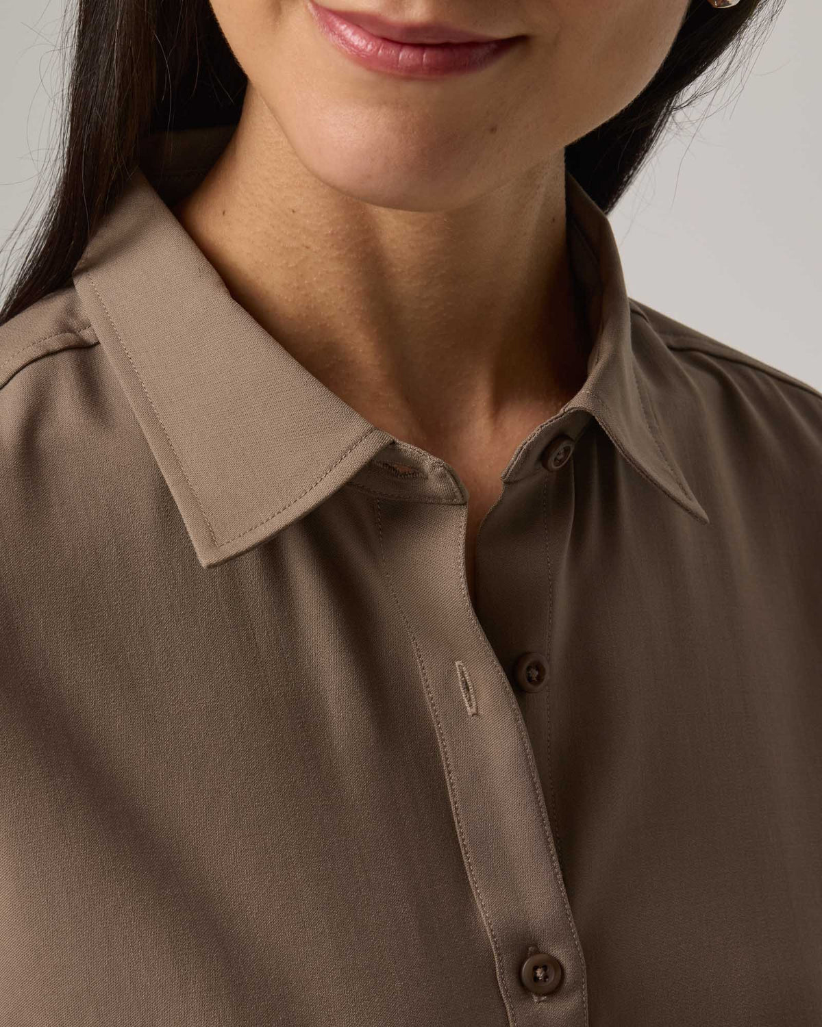 Model wearing Tiffany Button-Front Shirt in Walnut, a taupe brown color. Tiffany Button-Front Shirt is a merino wool long sleeve collared shirt available in sizes XS-XXL.