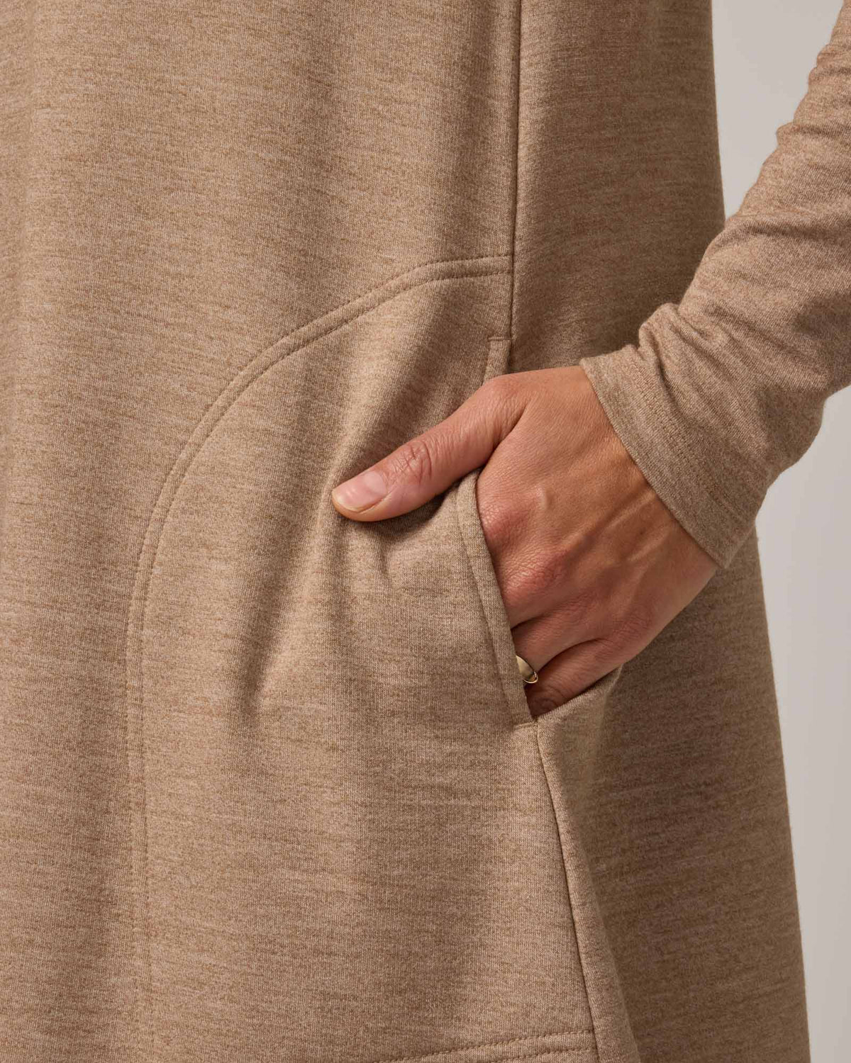Model wearing Eliza Swing Dress in Camel Heather, a warm heathered tan. Eliza Swing Dress is a merino wool long sleeve, crew neck, knee length swing dress with pockets available in sizes XS-3X Regular, XS-3X Long.