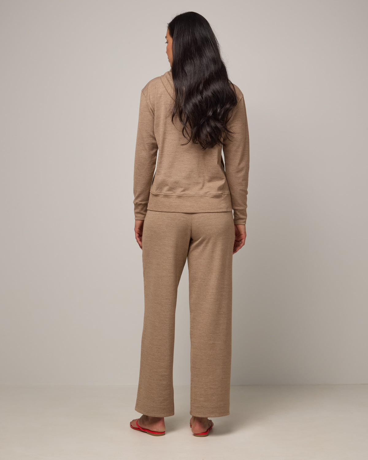 Model wearing Aspen Wide Leg Sweatpants in Camel Heather, a warm taupe heather color. Aspen Wide Leg Sweatpant is a merino wool, elastic waist pant available in sizes XS-3X. 