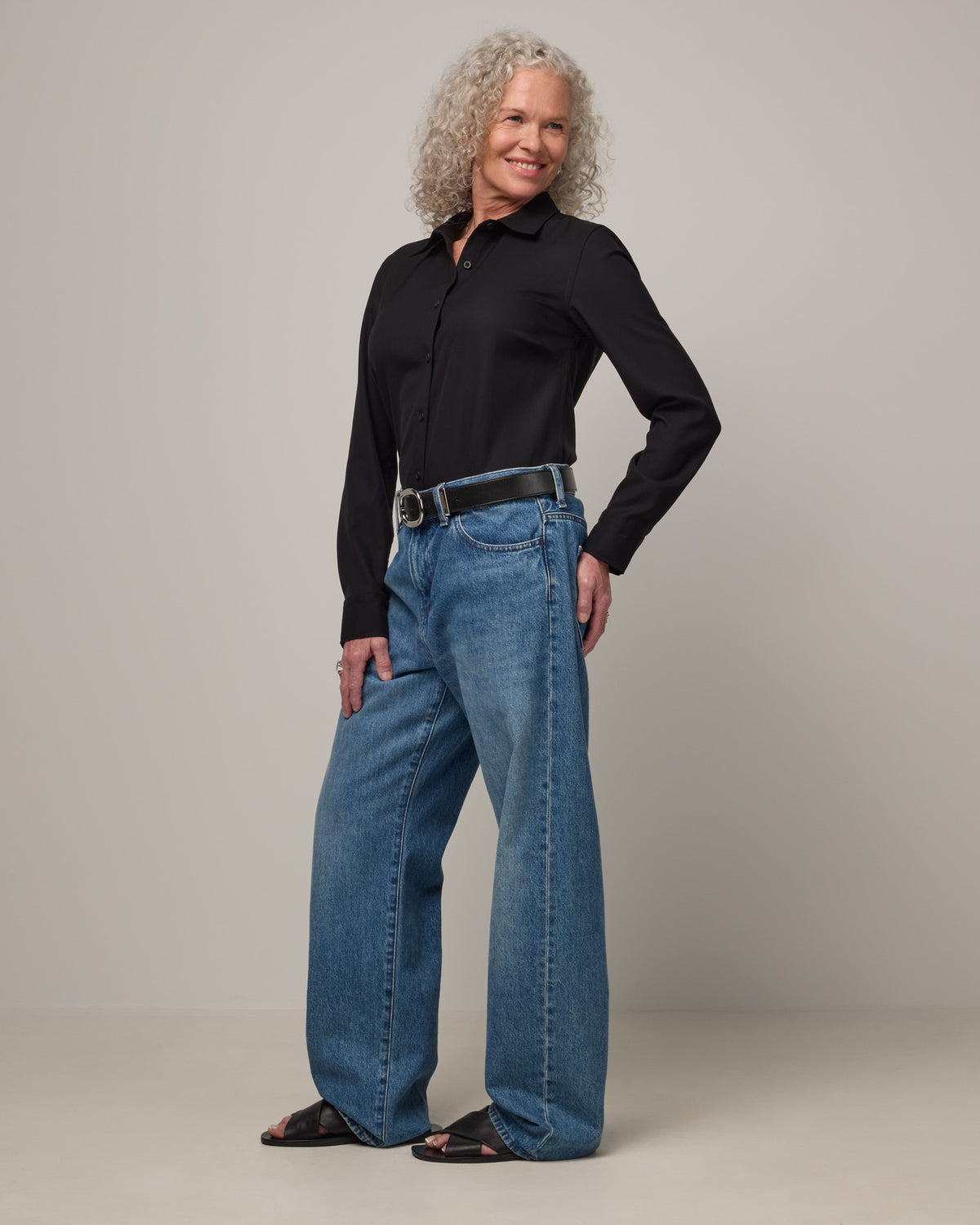Model wearing Tiffany Button-Front Shirt in Black. Tiffany Button-Front Shirt is a merino wool long sleeve collared shirt available in sizes XS-XXL.