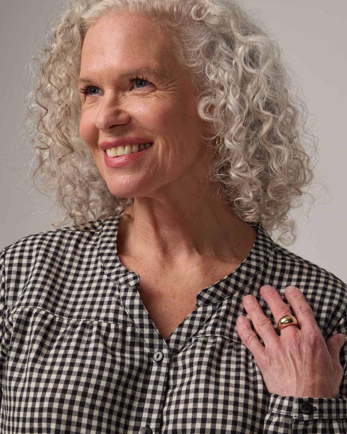 Model wearing Raquel Brushed Twill Top in Black & White Gingham. Raquel Brushed Twill Top is a 100% merino wool long sleeve, split collar button-front shirt available in sizes XS-XXL.